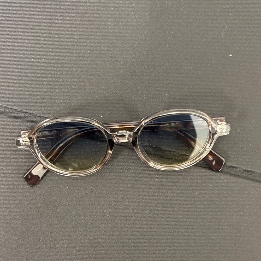 Transparent Oval Sunglasses with Dark Lenses